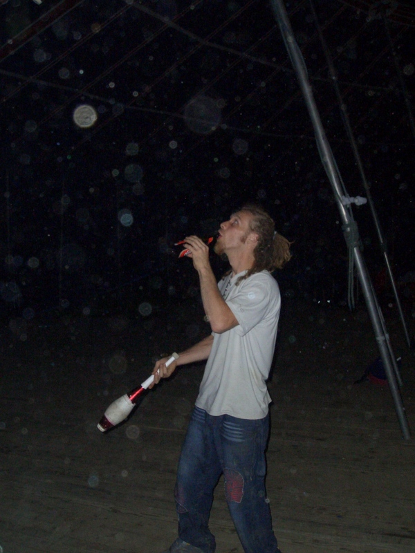 Martin juggling clubs while drinking beer
