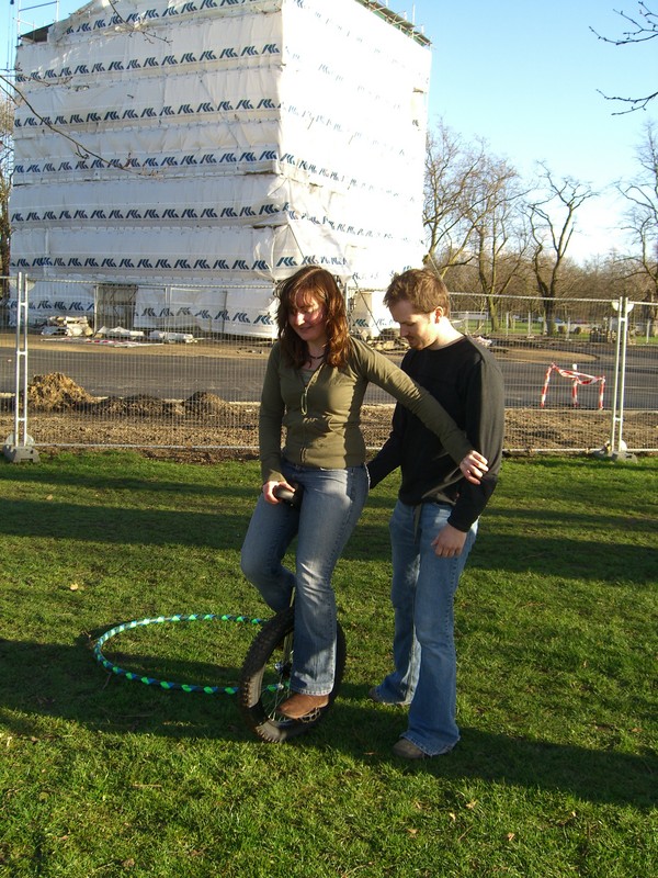 Toby helps Jemima to unicycle